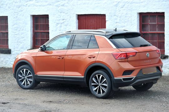 Orange Suv Parked Beside White Concrete Building