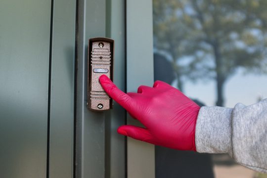 Person in Gray Long Sleeve Shirt Holding Gray Door Knob