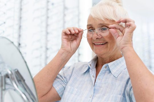 Senior woman trying on a new pair of glasses