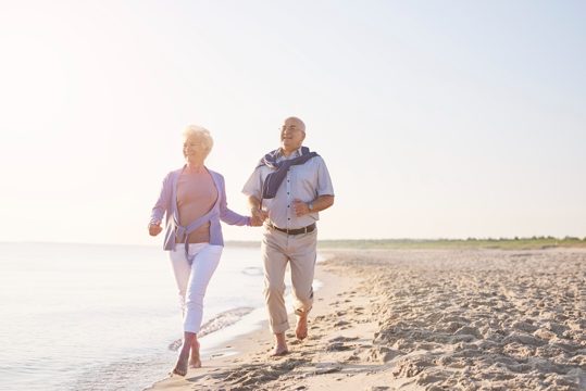 Vital seniors on the beach. senior couple in the beach, retirement and summer vacation concept