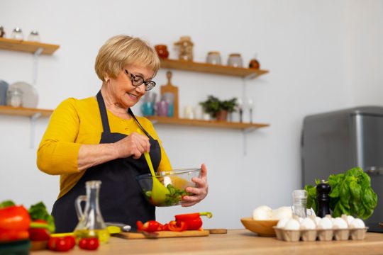 Medium shot woman cooking in kitchen