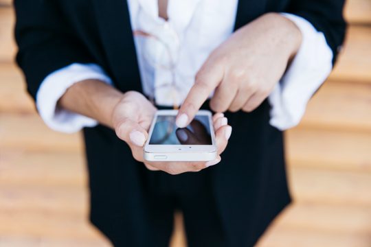 Close up view of businesswoman with smartphone