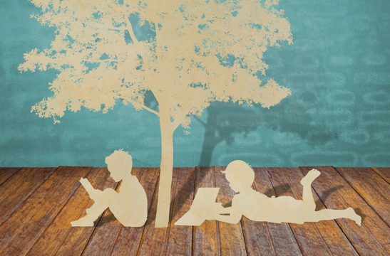 Paper cut of children read a book under tree