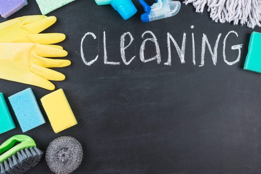 Chalk written cleaning text with various equipments