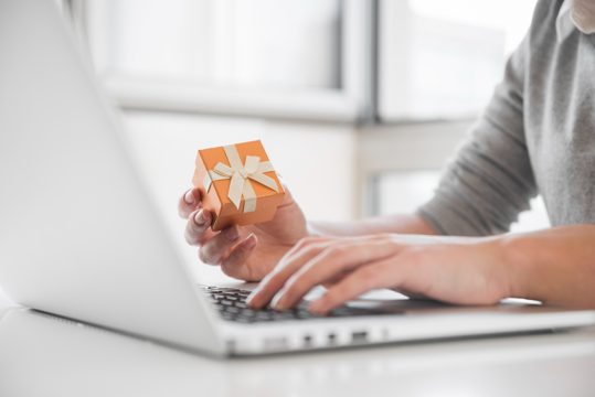 Woman sitting at table with laptop