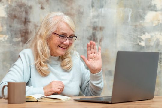 Low angle elder female working on laptop