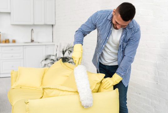 Front view of man using a duster