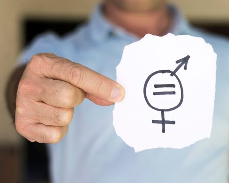 Blurred man holding paper with gender symbols