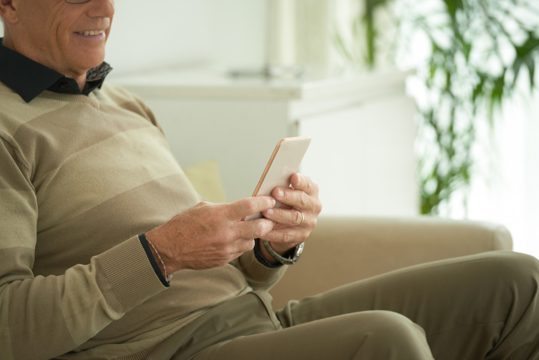 Aged man with smartphone