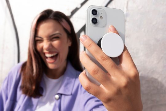 Front view young woman using popsocket