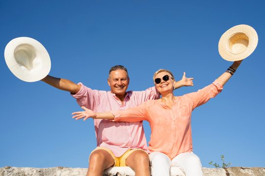 Medium shot couple sitting on cliff