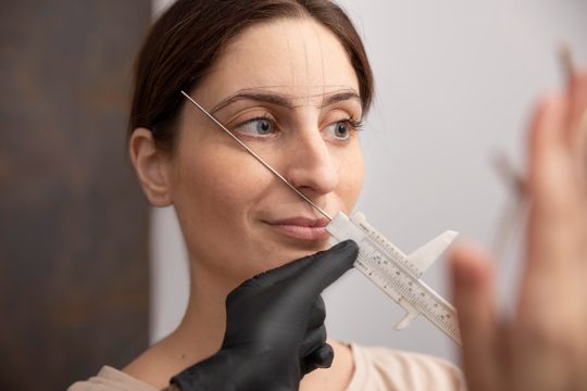 Woman going through a microblading procedure