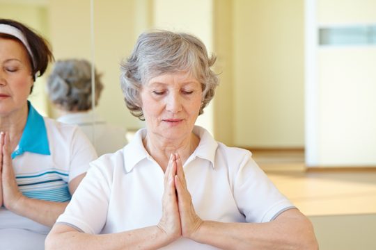 Woman in yoga pose sitting on the floor