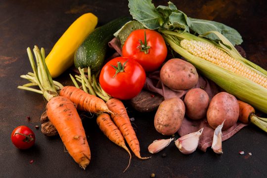 High angle arrangement of vegetables on dark background