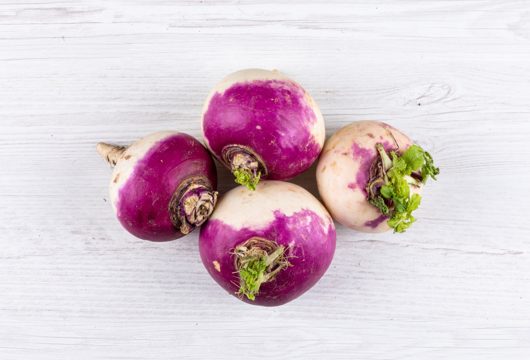 Close-up white radishes on white table