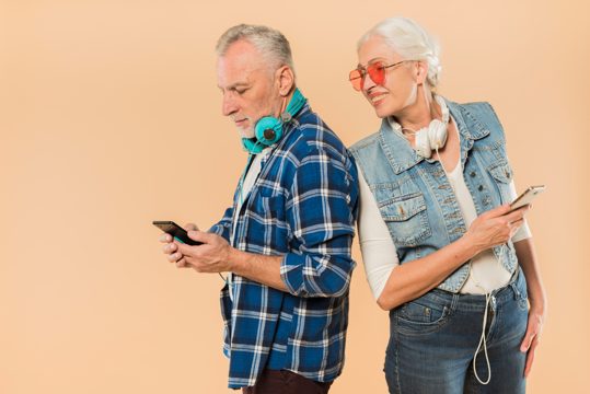 Cool senior couple with smartphone
