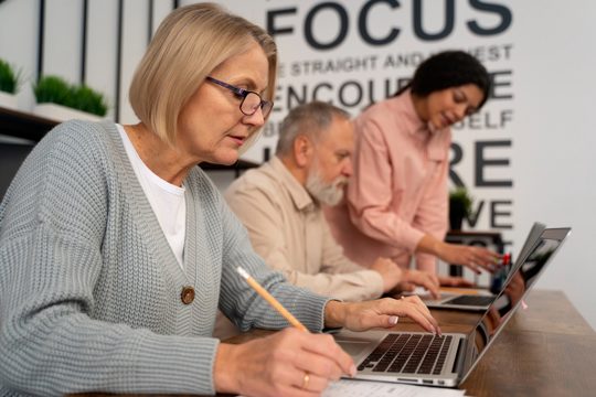 Senior people in school during class with laptop computer