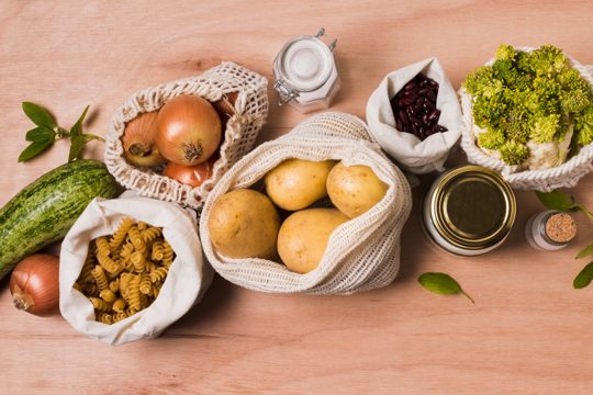 Flat lay arrangement of vegetables on wooden background