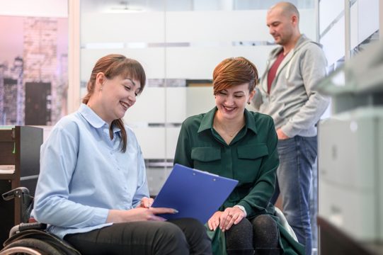 Handicapped young woman in office