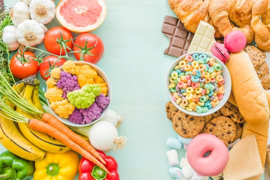 Overhead view of unhealthy and healthy food over the background