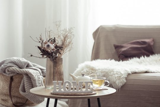 Home composition with decorative word home, tea and decor details.