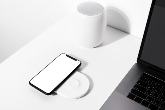 Smartphone on white wireless charger pad