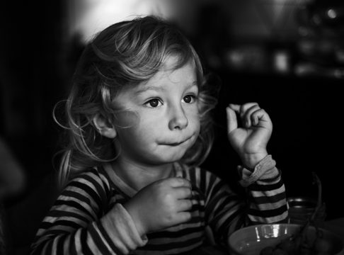 Grayscale shot of a young girl